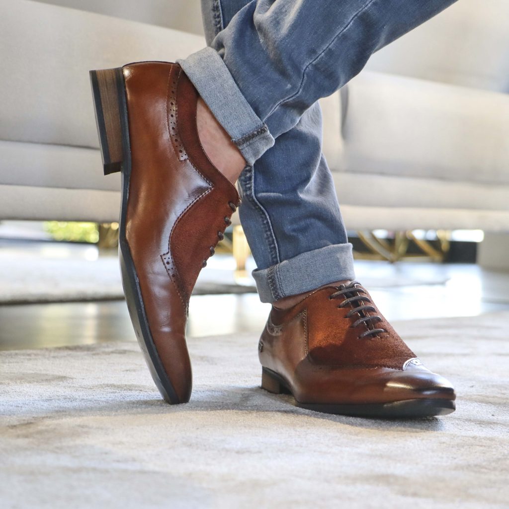 man wearing brown formal shoes